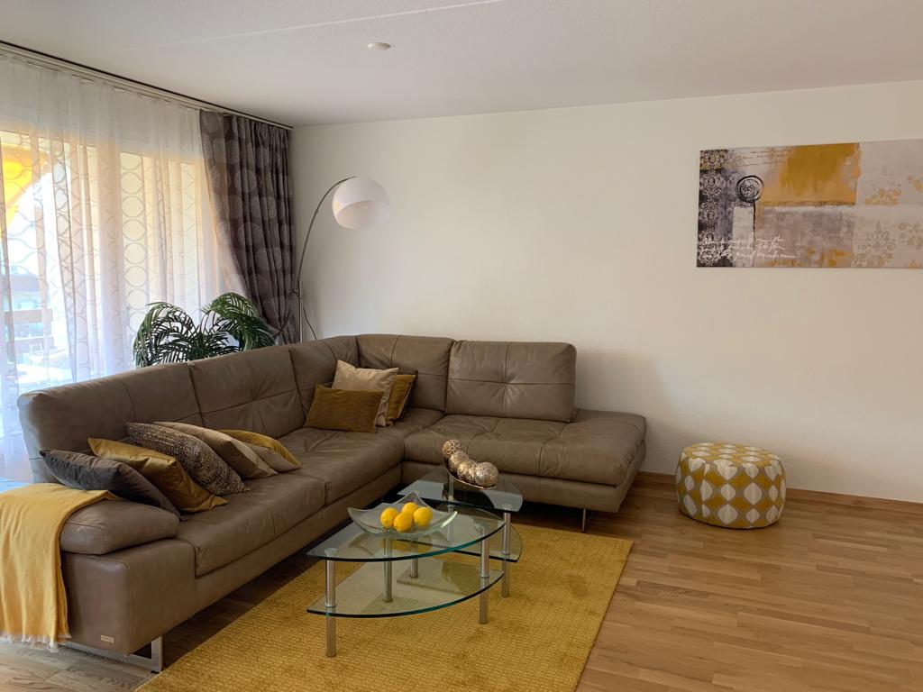 Brown corner sofa with neutral furnishings in the living room