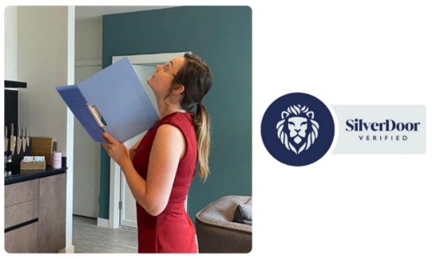 A woman with a folder checking the alarms on the ceiling.
