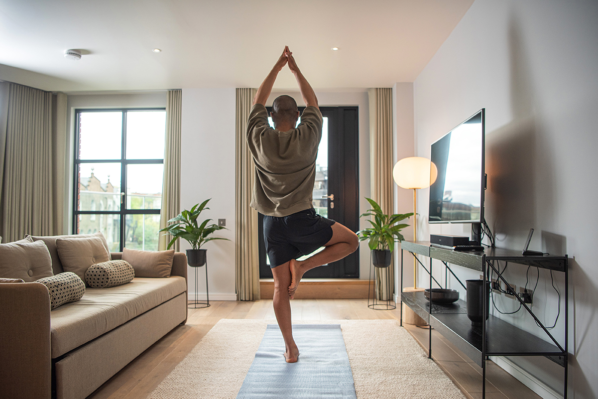 Male doing Yoga in an apartment