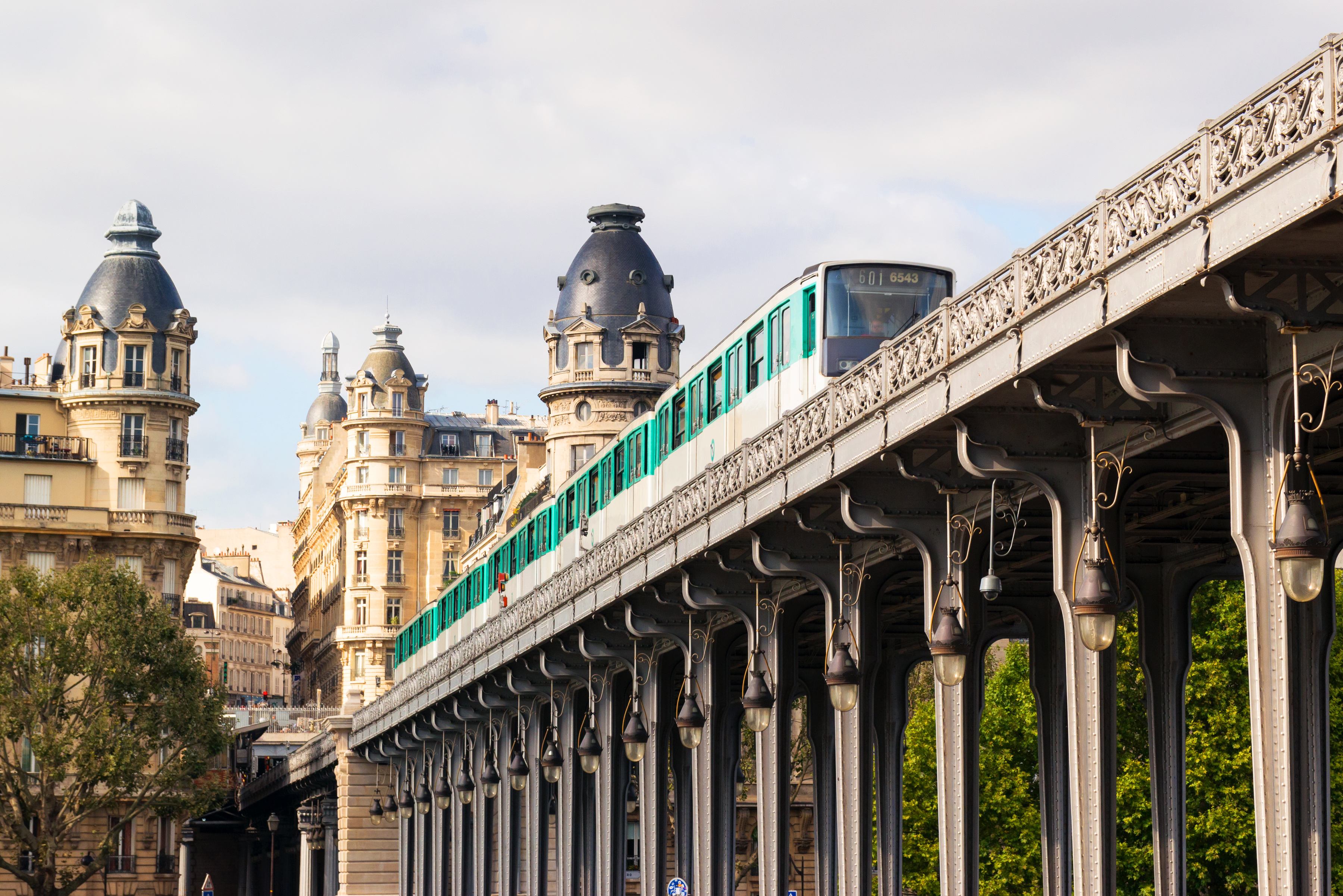Metro train runs high between buildings, Paris, France.