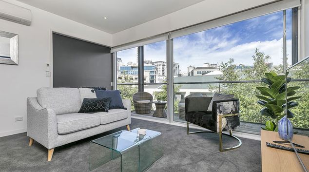 Living room at Design City Apartment, Queens Wharf, Auckland